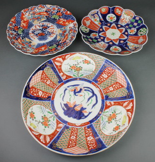 A late 19th Century Imari charger decorated with panels of trees and flowers enclosing an exotic bird 16", 2 smaller ditto 12" and 11 1/2" 