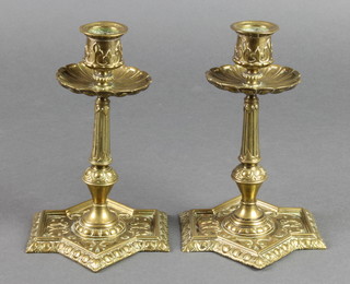 A pair of Victorian Art Nouveau brass candlesticks with shaped sconces and feet, 8" 