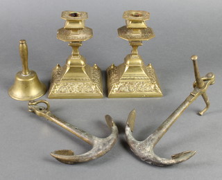 A pair of Victorian Art Nouveau square shaped squat candlesticks with detachable sconces 6", a table bell 4 1/2" and 2 model fishermen's anchors 7 1/2" 