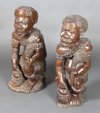 A large and impressive pair of African carved wooden figures of seated gentleman 25"h 