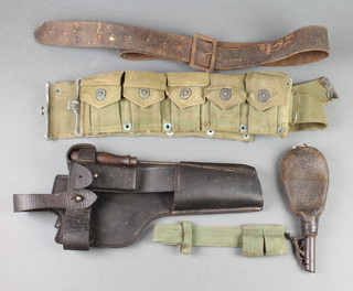 A 19th Century leather shot flask, an American webbing ammunition bandolier, a holster dated 1916