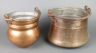 A circular Indian copper pot with swing handle 7" and 1 other with iron handle 8" 