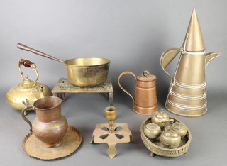 An 18th/19th Century brass saucepan with iron handle (handle f), a pierced brass footman, a brass kettle with glass handle, a lidded copper jug etc 