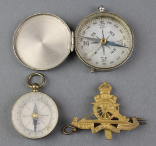 2 pocket compasses and a George VI Royal Artillery cap badge