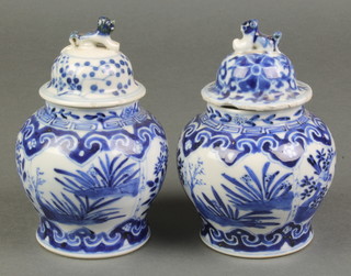 A pair of late 19th Century Chinese blue and white squat baluster vases  decorated with panels of garden views with 4 character mark to base 3 3/4" 