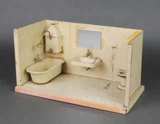 A pressed metal model dolls house insert of a bathroom with bath geyser, hand basin and lavatory, the hand basin, geyser and bath all with cisterns 6"h x 12"w x 7"d 