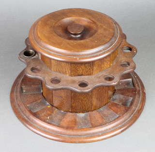 Dunhill, a circular mahogany Art Deco Dunhill Airtight patent tobacco jar, surrounded  by a pipe rack 6"h x 12" diam. 