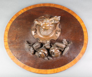 A pair of Italian carved walnut panels decorated dogs masks 19" x 14", ditto carved a boar's head 19" x 14" and an oval plaque carved deers head 19" 
