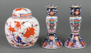 A 20th Century Imari ginger jar and cover decorated with flowers 6", a pair of similar baluster candlesticks 7" 