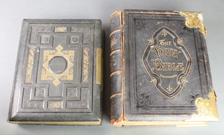 A Victorian leather bound Holy Bible, cover f and a Victorian leather bound family photograph album containing portrait photographs with brass lock and mount to side (f) 