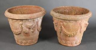 A pair of circular terracotta garden urns, the bodies cast swags 24"h x 28" diam. 