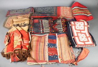 A Vietnamese embroidered apron together with various items of fabric and Persian saddle bag