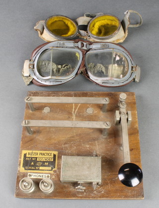An Air Ministry Buzzer practice morse key together with 2 pairs of goggles