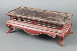 A Chinese rectangular red lacquered stand raised on out swept supports 6" x 15 1/2" w x 7"d