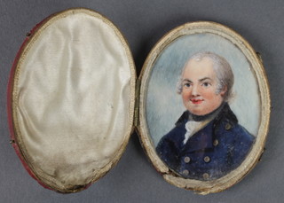 A 19th Century oval watercolour miniature of a gentleman wearing a blue frock coat in a red Moroccan leather case 3" x 2 1/2" 
