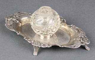 An Edwardian repousse silver ink stand with scroll decoration and scroll feet London 1901 6 1/2", 75 grams, a cut glass and silver mounted inkwell 