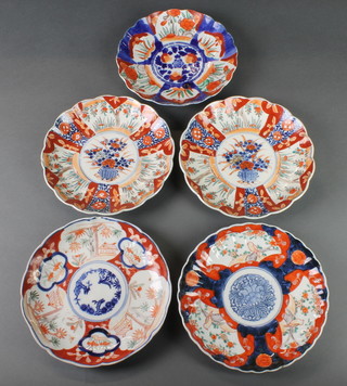 A pair of Imari scalloped dishes with a centre panel of flowers surrounded by panels of flowers 9" and 3 others