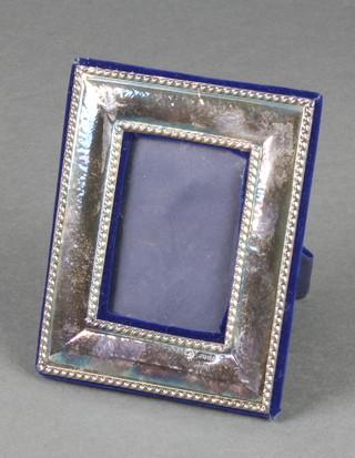 A rectangular silver photograph frame London 1989 5" x 4", boxed