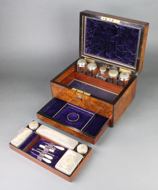A Victorian walnut toilet box with plated mounted jars and mother of pearl sewing implements