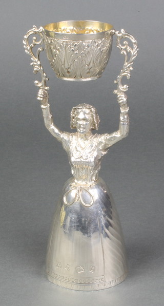 A cast silver wedding/wager cup of typical form with standing lady supporting a swinging cup with acanthus leaf decoration and gilt interiors Birmingham 1976 Maker Barrowclift Silvercraft 8", 376 grams