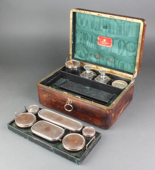 A Victorian leather bound toilet/jewellery box with silver plated mounted jars and compartments