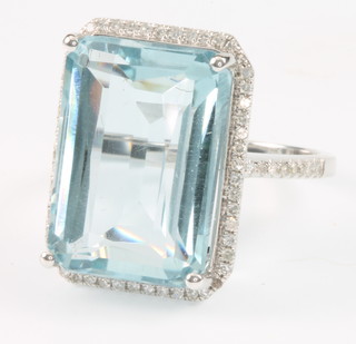 A 14ct white gold aquamarine and diamond dress ring, the centre stone approx. 15ct surrounded by brilliant cut diamonds approx. .4ct, size D 