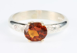 A silver gem set ring with cushion cut Madeira citrine in a gold mount, size O 