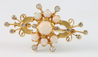 A yellow gold opal and diamond open brooch