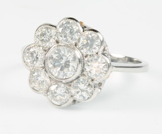 An 18ct white gold 9 stone daisy ring, approx. 1.6ct, size N