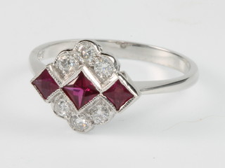 An 18ct white gold ruby and diamond Art Deco style ring with 3 princess cut rubies flanked by 6 brilliant cut diamonds size P 