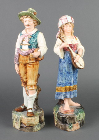 A pair of 19th Century Continental Majolica figures of standing musicians 16" 