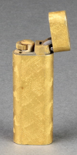 A lady's gold plated Cartier cigarette lighter with brushed decoration 