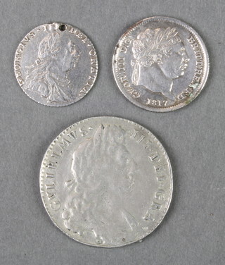 A George III shilling 1817, a George III sixpence 1787 (drilled) and 1 other coin