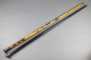 A Victorian repousse silver mounted ebonised walking cane, London 1887, a faux bamboo ditto with a plated knob