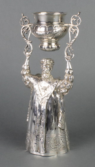A Continental repousse and chased silver wedding/wager cup in the form of a standing gentleman, import marks, Chester 1901, 610 grams, 11 1/2"  