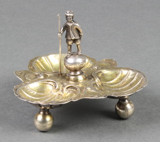 An 18th Century Continental silver gilt table salt in the form of 3 upturned shells, the handle in the form of a standing gentleman, raised on ball feet 3 1/2", 86 grams