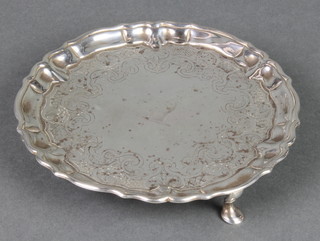 A George III silver card tray with pie crust rim and chased decoration enclosing an armorial 6 1/2" 