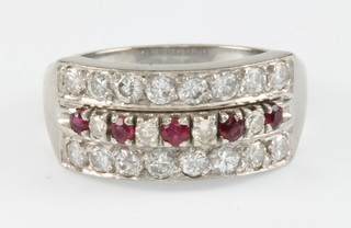 An 18ct white gold ruby and diamond cocktail ring comprising 3 rows of stones with 20 diamonds and 5 rubies, size Q