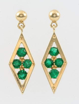 A pair of yellow gold gem set diamond shaped earrings