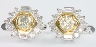 A pair of 14ct yellow and white gold brilliant and baguette cut diamond ear clips