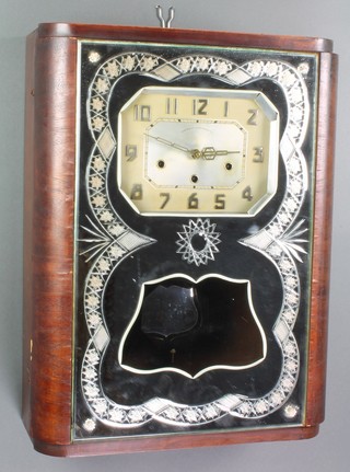 An Art Deco French 8 day chiming wall clock with octagonal silvered dial and Arabic numerals contained in a walnut and cut mirrored glass case, the dial marked Variable Westminster