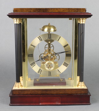 Brooks and Bentley, a striking battery operated skeleton clock contained in a 4 glass case