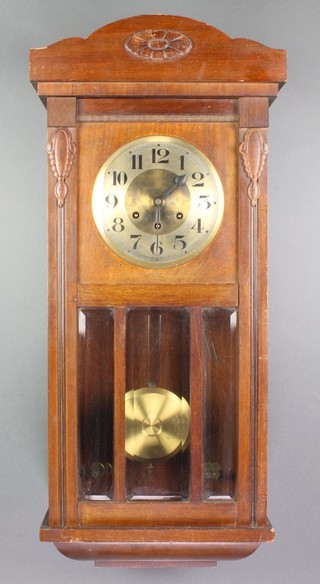 A 1930's chiming wall clock with 7" dial and Arabic numerals contained in an oak case
