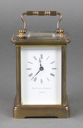 Matthew Norman, a 20th Century French carriage timepiece with enamelled dial and Roman numerals contained in a gilt metal case 