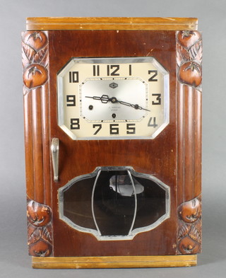 An Art Deco 8 day chiming wall clock with 10" octagonal dial marked E Bagourd, contained in a walnut and glass case 
