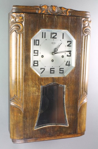 Girod, a French Art Deco 8 day chiming wall clock with 8 1/2" silvered dial contained in a walnut and glazed case