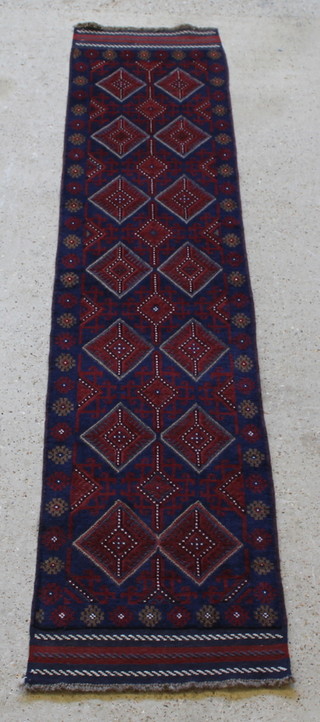A contemporary Meshwani red and blue ground runner with 14 diamonds to the centre 104" x 24" 
