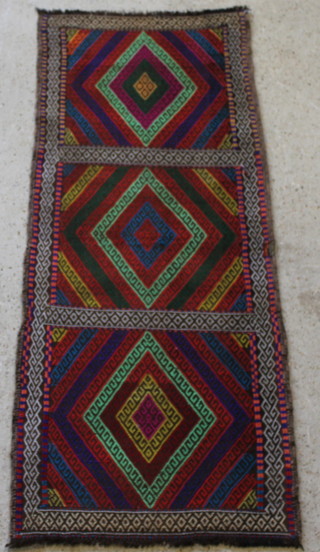 A contemporary brightly coloured Kilim rug having 3 diamonds to the centre 71" x 28" 
