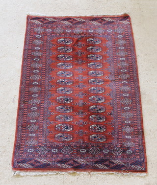 A tan ground Bokhara rug with 24 octagons to the centre 60" x 39" 