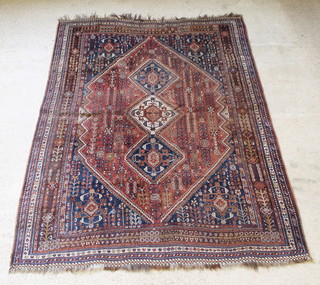A Persian Qashqai rug with brown and blue ground with 3 diamonds to the centre, in wear, 119" x 85" 